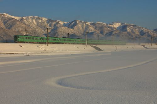 湖西線の朝陽に輝く湖北の冠雪した山々バックに行く113系ローカル電車他(マキノ~永原)